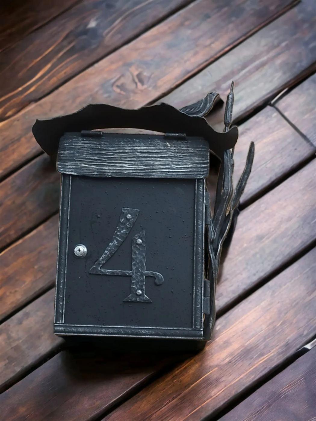 Forged mailbox with a house number