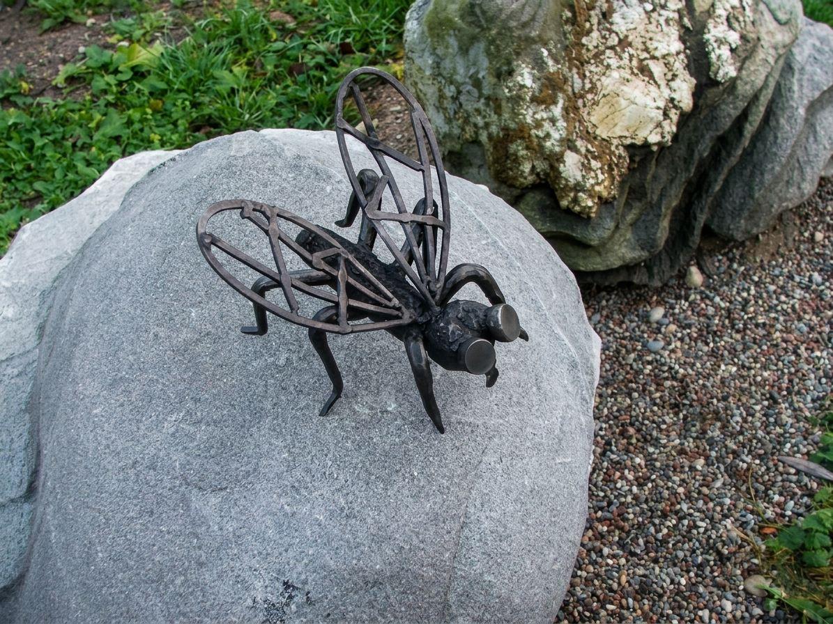 Fly sculpture on a stone