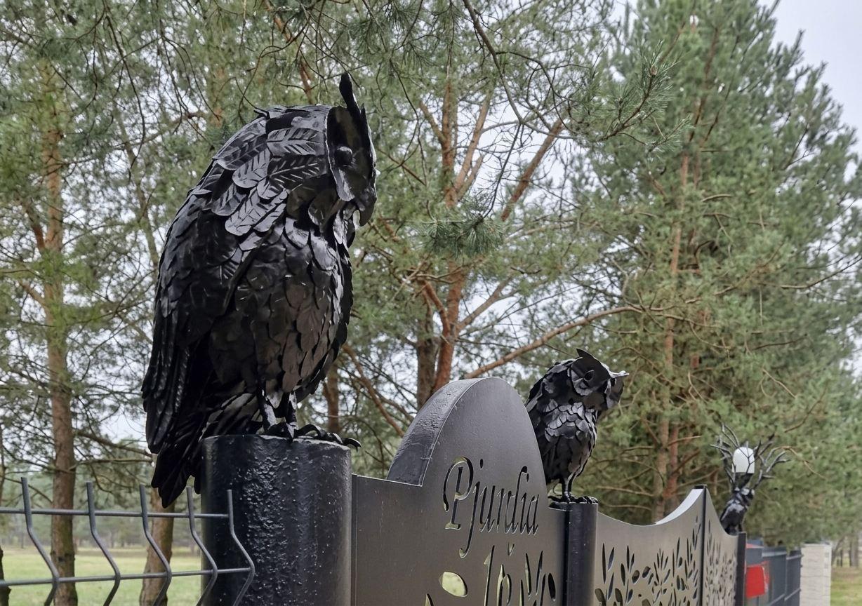 Owl sculptures on a gate